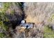 Aerial view of a home with a deck, storage buildings, and surrounding bare trees at 237 Creekstone Ln, York, SC 29745