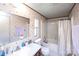 The bathroom features a vanity, toilet and shower/tub combination and floral wallpaper at 237 Creekstone Ln, York, SC 29745