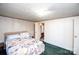 Comfortable bedroom features a bed with quilt and view into the attached full bathroom at 237 Creekstone Ln, York, SC 29745