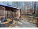 Wooden deck features a gazebo with a swing set, railing, and serene forest backdrop at 237 Creekstone Ln, York, SC 29745