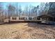 A cozy single-story home with a carport and a small storage shed nestled among the trees at 237 Creekstone Ln, York, SC 29745