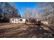 Exterior home view featuring a deck, sloped yard, and mature trees in the background at 237 Creekstone Ln, York, SC 29745