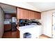 A kitchen features stainless steel appliances, wood cabinets and flows into the living room area at 237 Creekstone Ln, York, SC 29745