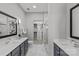 Modern bathroom featuring double vanity sinks, marble floors, glass enclosed shower and walk-in closet at 2401 Euclid Ave # 213, Charlotte, NC 28203