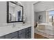 Stylish bathroom with modern vanity, sleek mirror, and a doorway leading to the bedroom at 2401 Euclid Ave # 213, Charlotte, NC 28203
