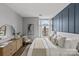 Beautiful bedroom with hardwood floors, blue accent wall, and large windows, perfect for relaxing at 2401 Euclid Ave # 213, Charlotte, NC 28203