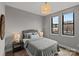 Cozy bedroom with two windows, a comfortable bed, and a nightstand at 2401 Euclid Ave # 213, Charlotte, NC 28203