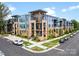 Beautiful multi-story condo building showcases blue and tan exterior, manicured landscaping, and convenient street parking at 2401 Euclid Ave # 213, Charlotte, NC 28203