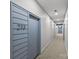 Hallway featuring carpet, modern lighting, and muted blue doors with unit number 213 at 2401 Euclid Ave # 213, Charlotte, NC 28203