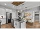 Stainless steel refrigerator stands out in this island kitchen with a view into the dining area at 2401 Euclid Ave # 213, Charlotte, NC 28203