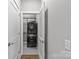 Well-organized laundry area with stacked washer and dryer, accessible through a hall with stylish doors at 2401 Euclid Ave # 213, Charlotte, NC 28203