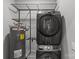 Modern laundry room with stacked washer and dryer and shelving for convenient organization and storage at 2401 Euclid Ave # 213, Charlotte, NC 28203