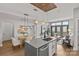 Open floor plan with kitchen island, dining area, and living room filled with natural light and modern finishes at 2401 Euclid Ave # 213, Charlotte, NC 28203