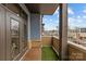 Balcony featuring artificial grass, wood flooring, brick railing, and views at 2401 Euclid Ave # 213, Charlotte, NC 28203