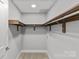 Spacious walk-in closet with custom wood shelving and ample storage space at 2401 Euclid Ave # 213, Charlotte, NC 28203