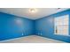 This bedroom features bright blue walls, a window with blinds, and neutral carpeting at 241 Catoctin Rd, Rock Hill, SC 29732