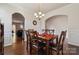 Open dining room featuring a wooden table, wainscoting, and views of the kitchen with dark cabinetry and stainless steel appliances at 241 Catoctin Rd, Rock Hill, SC 29732