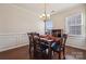 Dining room featuring a wooden table set with six chairs, wainscoting, a chandelier, and natural light from a nearby window at 241 Catoctin Rd, Rock Hill, SC 29732