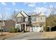 Two-story home featuring brick accents, a two-car garage, well-maintained landscaping, and a basketball hoop on the driveway at 241 Catoctin Rd, Rock Hill, SC 29732