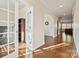 Hallway with rich hardwood flooring and arched openings, leading to an office with French doors and a view of the living area at 241 Catoctin Rd, Rock Hill, SC 29732