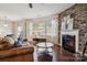 Bright living room with hardwood floors, large windows offering natural light, comfortable seating, and a cozy fireplace at 241 Catoctin Rd, Rock Hill, SC 29732