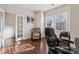 Cozy office with hardwood floors, a window with natural light, and a chair, situated near a glass door leading to the hallway at 241 Catoctin Rd, Rock Hill, SC 29732