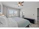 Bright bedroom with neutral walls, large windows, ceiling fan, and access to bathroom at 2419 Paddlers Cove Dr, Clover, SC 29710