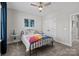 Cozy bedroom featuring a modern ceiling fan, natural light, and closet at 2419 Paddlers Cove Dr, Clover, SC 29710