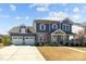 Charming two-story home featuring a two-car garage, stone accents, and landscaped front yard at 2419 Paddlers Cove Dr, Clover, SC 29710