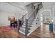 Elegant foyer showcases a staircase with metal spindles, an adjacent dining room, and open sightlines at 2419 Paddlers Cove Dr, Clover, SC 29710