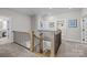 Upstairs hallway featuring wooden banisters and neutral decor leading to bedrooms and bathrooms at 2419 Paddlers Cove Dr, Clover, SC 29710