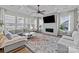 Spacious living area with a fireplace, large windows, and comfortable seating for relaxing or entertaining at 2419 Paddlers Cove Dr, Clover, SC 29710