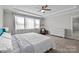 Bright main bedroom features ample natural light, a ceiling fan, and a cozy seating area at 2419 Paddlers Cove Dr, Clover, SC 29710