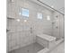 Luxurious walk-in shower with marble-look tiling, a built-in bench, and contemporary glass doors at 2419 Paddlers Cove Dr, Clover, SC 29710