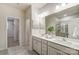 Bright bathroom with double vanity sinks, a large mirror, and a glass-enclosed shower at 2534 Crimson Way, Monroe, NC 28112