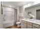 Bright bathroom with double vanity, large mirror, tub and shower combo and modern fixtures at 2534 Crimson Way, Monroe, NC 28112