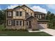Striking two-story home with stone accents, large windows, and a two-car garage at 2534 Crimson Way, Monroe, NC 28112