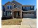 Charming two-story home with a stone entrance, a two-car garage, and a well-maintained lawn at 2534 Crimson Way, Monroe, NC 28112