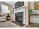 Close-up view of a modern fireplace with a white mantel and a sleek black surround at 2534 Crimson Way, Monroe, NC 28112