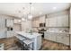 Bright kitchen featuring a large island with seating, stainless steel appliances, and ample cabinet space at 2534 Crimson Way, Monroe, NC 28112
