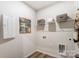 Functional laundry room with storage shelves, a utility sink, and modern appliances at 2534 Crimson Way, Monroe, NC 28112