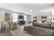 Bright living room with large television, couch, chairs, and lots of space for entertaining at 2534 Crimson Way, Monroe, NC 28112