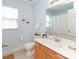 Bathroom with wooden cabinets, white countertops and hanging plants at 2627 Bridgeville Ln, Charlotte, NC 28262