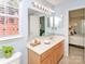 Bathroom with white countertop, wooden cabinets and decorative vanity mirror at 2627 Bridgeville Ln, Charlotte, NC 28262