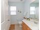 Bathroom with wooden cabinets, white countertops and hanging plants at 2627 Bridgeville Ln, Charlotte, NC 28262