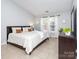 Spacious bedroom with tile floors, natural light, and large bed at 2627 Bridgeville Ln, Charlotte, NC 28262