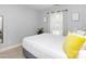 Bright bedroom with white bedding, plants and view into the bathroom at 2627 Bridgeville Ln, Charlotte, NC 28262
