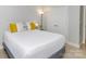 Comfortable bedroom featuring white bedding, neutral colored pillows and tile flooring at 2627 Bridgeville Ln, Charlotte, NC 28262