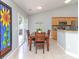 Dining area with table, seats four, features tile floors, and glass doors to let the light shine in at 2627 Bridgeville Ln, Charlotte, NC 28262