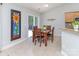 Light filled dining area showing the table, chairs, tile floors, and glass doors to let the light shine in at 2627 Bridgeville Ln, Charlotte, NC 28262